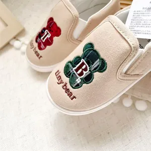 Detailed view of the cute embroidered bear and Tinybear text on children's canvas shoes