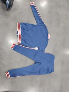 Detailed view of blue heavyweight fleece men's tracksuit with striped ribbed cuffs
