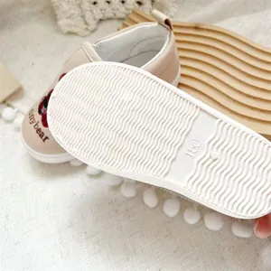 Close-up detail of children's canvas slip-on shoe with non-slip white wavy sole