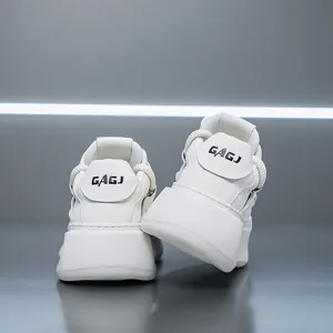 Close-up rear view of trendy white chunky platform sneakers with GAGJ logo detail