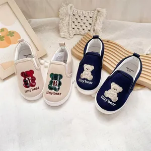 Children's slip-on canvas sneakers with cute bear embroidery and Tiny Bear branding