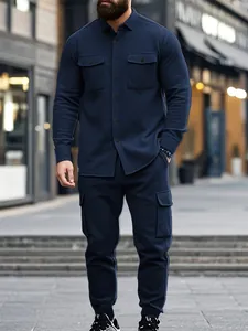Outdoor full body shot of a men's navy blue heavy fleece cargo jacket and pants set