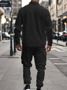 Back view of a man in black heavy fleece workwear jacket and cargo pants set on a street