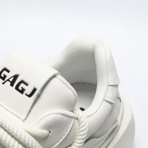 Detailed close-up of white chunky bread shoes showing breathable mesh lining and soft collar