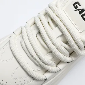 Macro view showing detail of white platform bread sneakers with thick woven laces