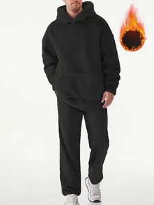Close-up of men's black coral fleece hoodie set showing thick thermal texture