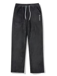 Detailed view of men's soft black coral velvet lounge pants featuring a white drawstring