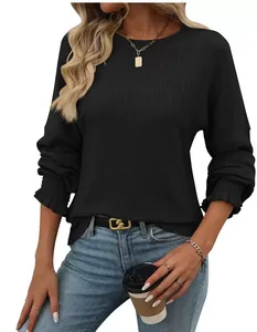 Detailed view of women's black ribbed long-sleeve T-shirt with ruffled cuffs and round neck