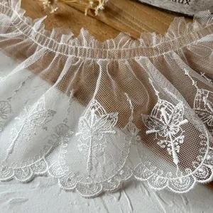 Close-up of white mesh embroidered butterfly lace trim for DIY garment detailing