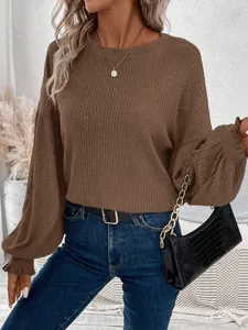 Close-up detail of brown ribbed knit texture and stylish lantern sleeves on loose top