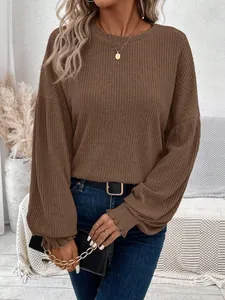 Detail view of brown ribbed long sleeve t-shirt with a loose fit and round neck.