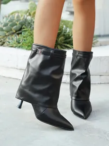 Black pointed-toe fold-over pant-leg boots with stiletto heel and buckle detail.