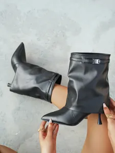 Detailed view of black pointed-toe stiletto boots with stylish slouchy pant-leg design.