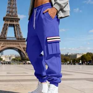 Close-up detail of blue men's fleece cargo sweatpants with multi-pockets and stripes