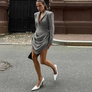 Detailed view of grey slim fit deep V-neck blazer dress with draped waist styling.