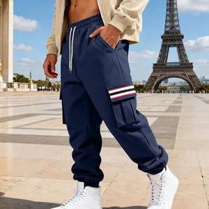 Detail view of navy blue cargo sweatpants featuring a stylish striped pocket flap.