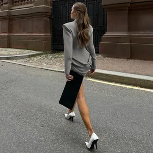 Elegant slim fit gray blazer dress with unique pleated back detail shown on street model
