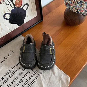 Detailed shot of children's warm fleece-lined moccasins with stylish suede texture