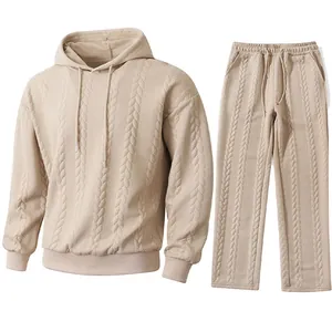 Close-up detail of men's beige cable knit jacquard hoodie and matching pants set