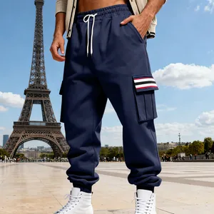 Detail of navy blue men's cargo pants with drawstring and striped pocket flap