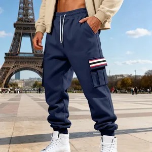 Male model wearing navy blue cargo sweatpants with striped pocket detail in Paris
