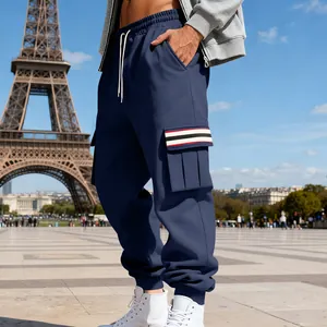 Detailed view of men's navy fleece cargo pants with striped pocket and jogger cuffs.