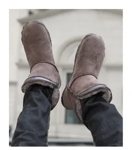 Detailed view of brown suede snow boots with thick faux fur lining for winter warmth