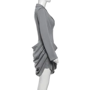 Detailed side view of grey slim-fit blazer dress featuring draped ruched skirt design