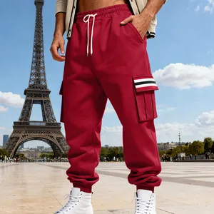Close-up detail of red men's fleece cargo pants with multi-pockets and striped accents