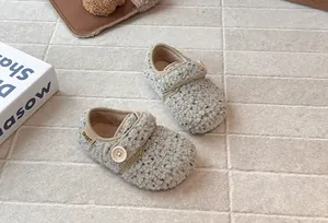 Detail view of textured grey fleece toddler shoes with button for winter warmth