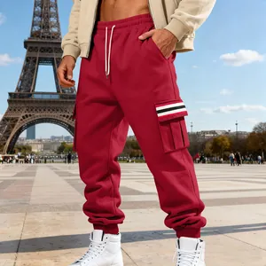Detail view of men's red cargo sweatpants with striped pocket design in Paris.