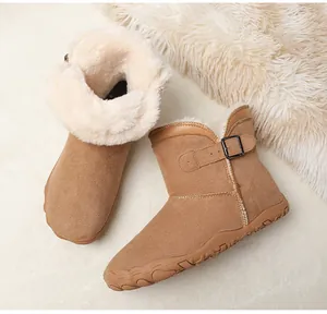 Top-down view of brown suede snow boots with thick white faux fur lining and buckle