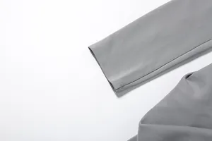 Macro detail of the gray sleeve cuff with double topstitching on a slim fit blazer dress.