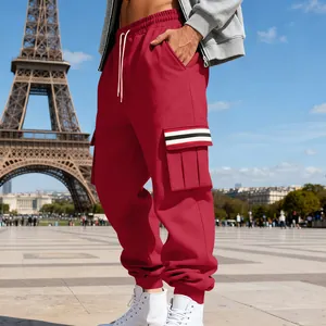 Men's red fleece-lined cargo sweatpants with striped side pocket detail outdoors