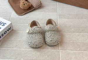 Close-up detail of cozy woolly fleece button-up Birkenstock-style shoes for girls