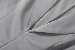 Close-up detail of the elegant deep V-neck stitching on the grey blazer dress fabric.