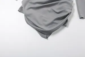 Close-up detail of the elegant grey draped fabric on this slim-fit autumn dress