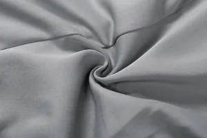 Macro view of high-quality gray suit dress fabric showing fine texture and smooth drape