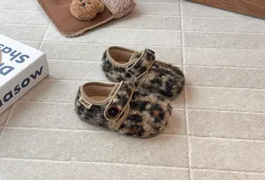 Detailed view of leopard print fuzzy toddler shoes with button closure