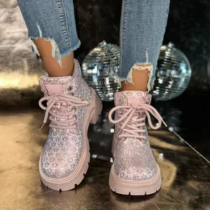 Close-up of pink rhinestone Martin boots with glitter finish and lace-up design