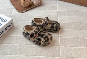 Close-up of cozy leopard print fuzzy button shoes for kids autumn winter design