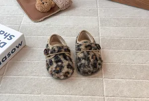 Detailed view of stylish leopard print fuzzy toddler shoes featuring a French button closure