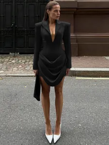 Elegant slim-fit black blazer dress with deep V-neck and draped waist design for women.