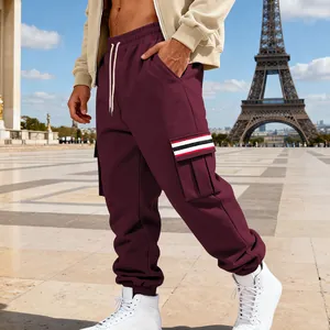 Detailed macro view of men's burgundy fleece cargo pants featuring striped side pocket