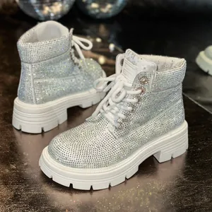Detail view of sparkly white rhinestone-encrusted Martin boots with thick lug sole