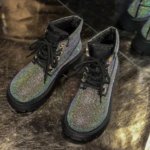 Close-up detail of shimmering multicolored rhinestones on black lace-up Martin boots