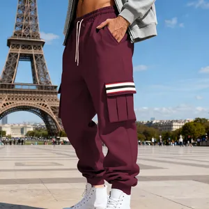 Close-up of men's burgundy cargo sweatpants with striped pocket detail and elastic cuffs