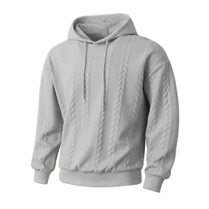 Detailed macro view of grey jacquard textured men's hooded sweatshirt with cables.
