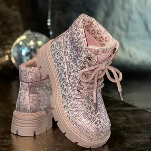 Detailed view of pink rhinestone-studded Martin boots featuring elegant floral lining.