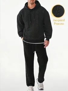 Detailed macro view of black men's hooded jacquard texture sweatshirt and pants set
